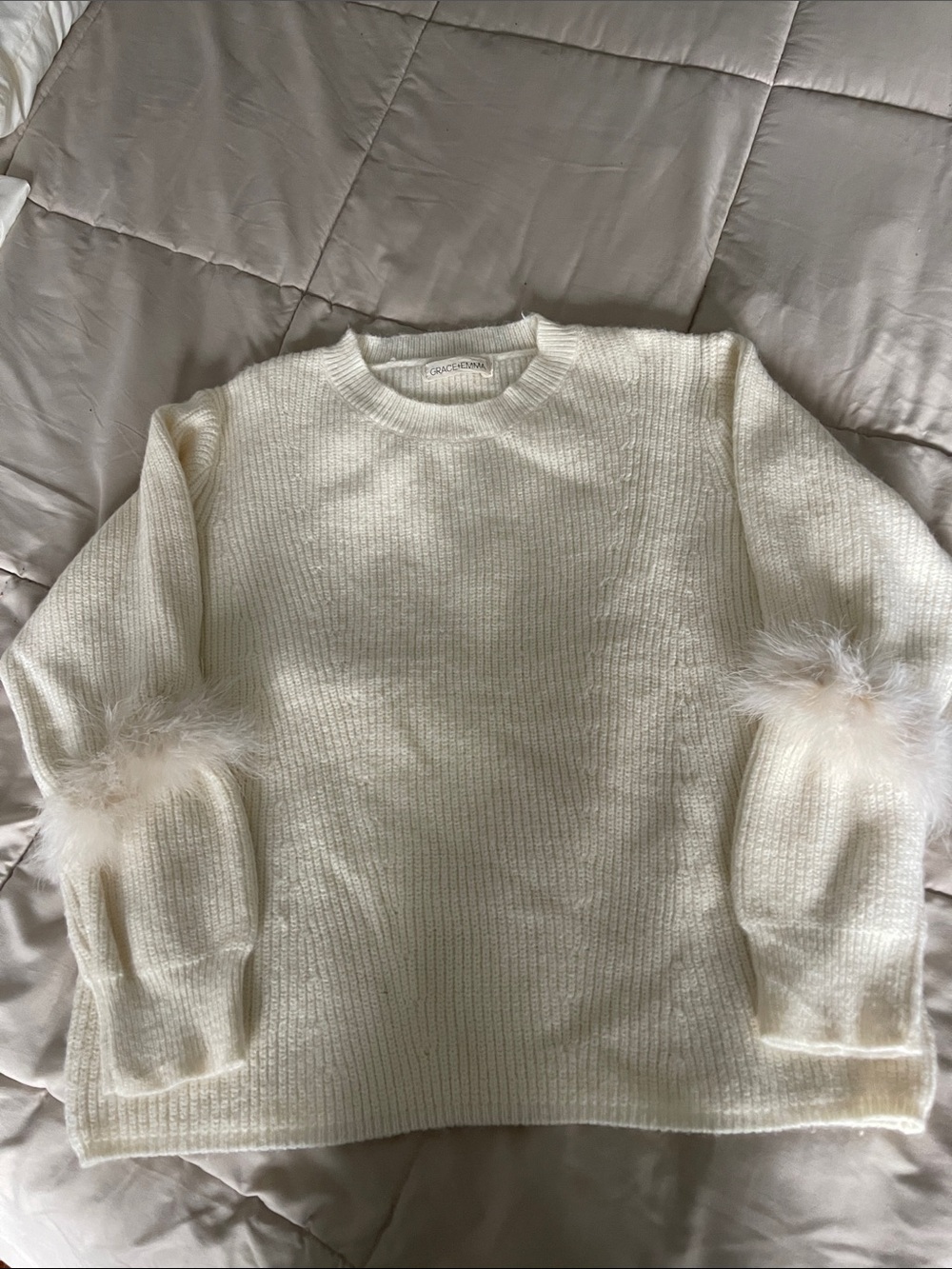 Grace & EmmaCream Feather Cuff Knit Sweater size large- Never worn. NWOT